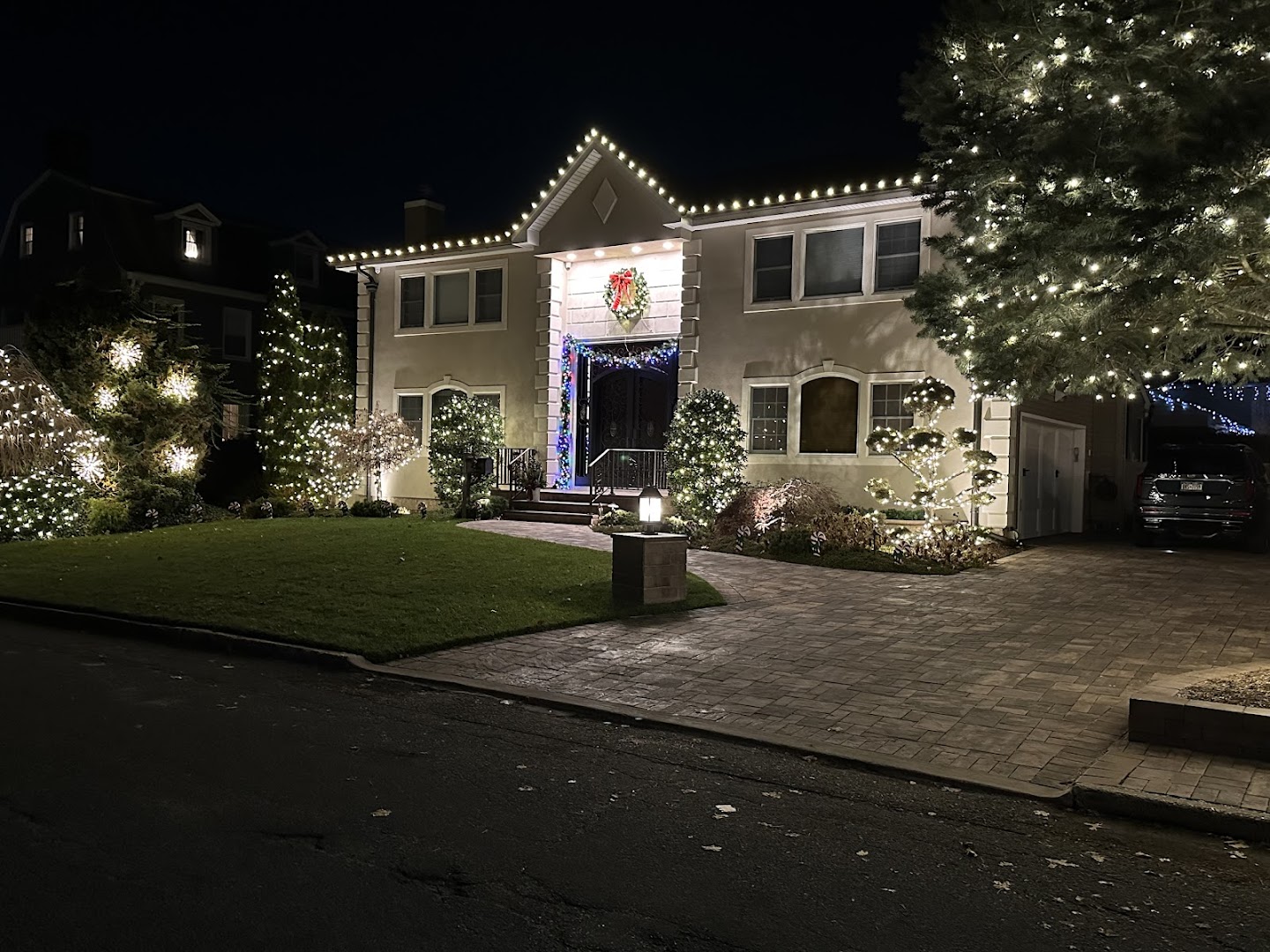 Long Island home with holiday lighting at dusk, NY